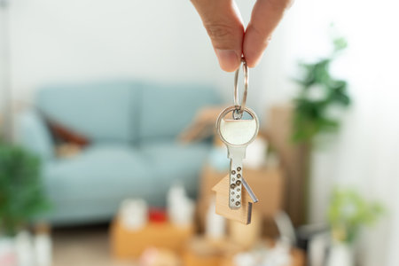 Moving house, relocation. Man hold key house keychain in new apartment. move in new home. Buy or rent real estate. flat tenancy, leasehold property, new landlord, investment,の写真素材