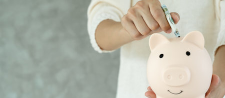 Save money. woman show piggy bank for saving. wealth, Finance, business, investment, retirement, future, accounting, plan life, economize, banking, family, health.の写真素材