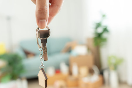 Moving house, relocation. Man hold key house keychain in new apartment. move in new home. Buy or rent real estate. flat tenancy, leasehold property, new landlord, investmentの写真素材