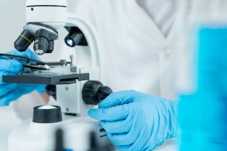 Scientist analyze biochemical samples in advanced scientific laboratory. Medical professional use microscope look microbiological developmental of viral. Biの写真素材