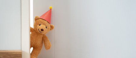 Teddy bear playing hide and seek behind the door, Adorable child having fun in the home. happy family have fun with kids, activity, learning,の写真素材