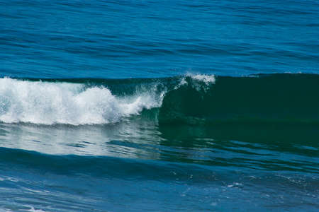 a wave in the ocean with the curl, white roll