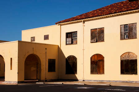abandon building building with weathered boards on the windows, peeling paint, blue skyの写真素材
