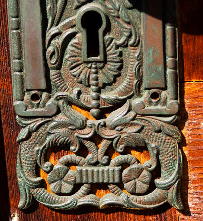 victorian decorative key hole plate made out of metal with fish designの写真素材