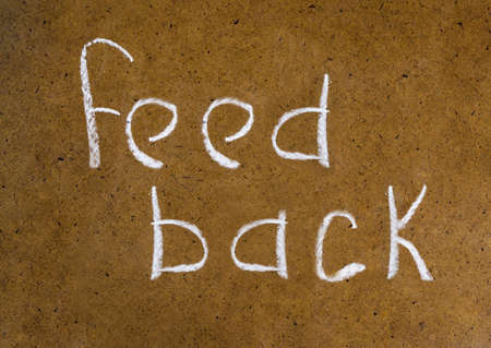 feedback handwritten inscription in chalk on a plain backgroundの写真素材