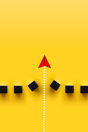 Concept of overcoming barriers, goal, target. Red paper plane