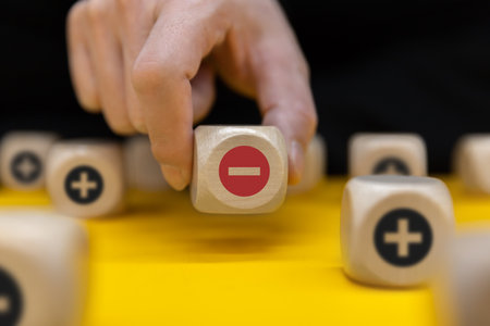 Plus and minus icons on wooden cubes. Separate the negative from positive, removing the weaknesses or negativity, positive thinking, negative feedback or subtractionの写真素材