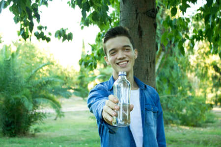 Young man holding a bottle of waterの写真素材