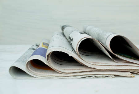Stack of newspapers on white background.の写真素材