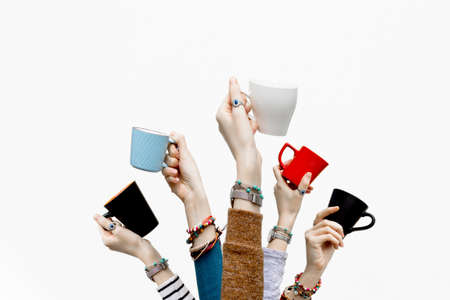 Many different hands holding coffee cups isolated on white background.