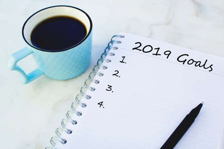 2019 goals list with cup of coffee on a marble background.