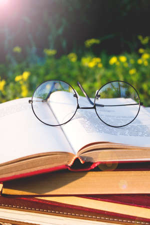 Glasses on old open book.