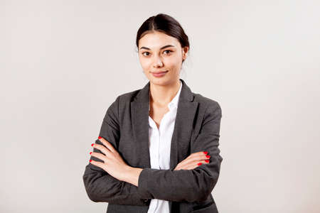 Portrait of businesswoman on gray background.の写真素材