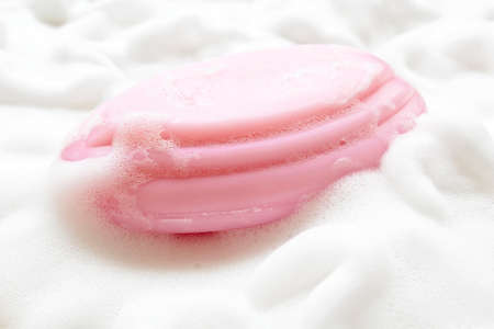 Pink soap on foam bubbles background.の写真素材