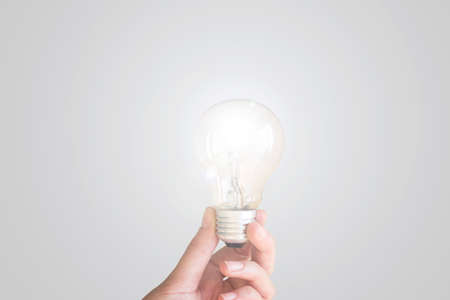 Woman hand holding a light bulb.の写真素材