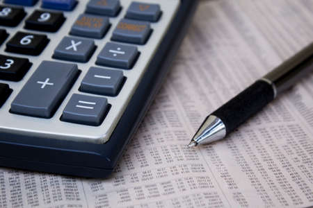 Calculator with pen on paper.の写真素材