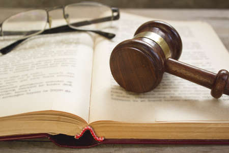 Reading glasses and judge gavel on the book.