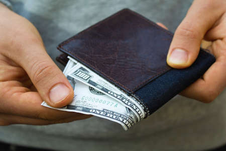 Man takes money from the wallet.の写真素材