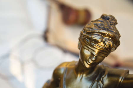 Statue of justice, judge gavel and open books.の写真素材