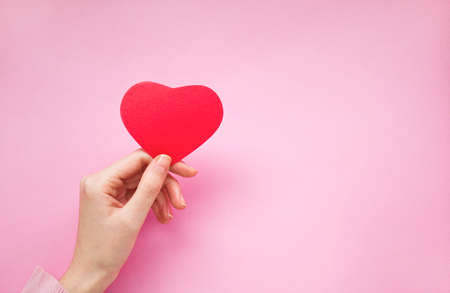 Woman hand holding a heart shape card.の写真素材