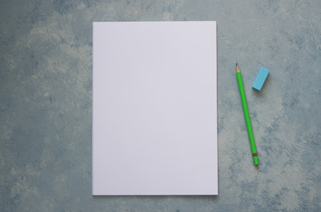 Blank paper on gray background, pencil and eraserの写真素材