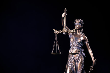 Statue of Themis Lady of Justice symbol on black backgroundの写真素材
