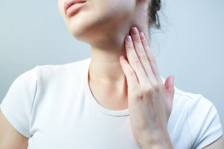 Sick woman suffers from sore throat. Seasonal illness.