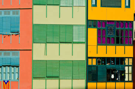 Close up of colorful old houses and windows. Girona, Spain. Color blocks architecture background.のeditorial素材