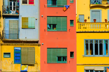 Close up of colorful old houses and windows. Girona, Spain. Color blocks architecture background.のeditorial素材