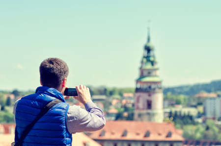 Young man making mobile camera photo