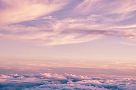 Abstract background with pink, purple and blue colors clouds. Sunset sky above the clouds. Dreamy fantasy background in soft pastel colors.の写真素材