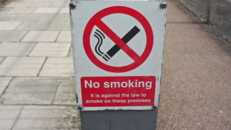No smoking sign standing on floor in public area.の写真素材