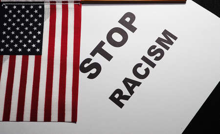 Stop racism, text message with American flag. Banner for protest or human rights action.の写真素材