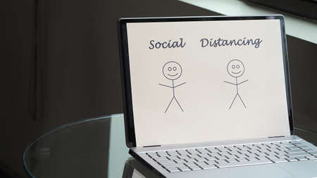 Laptop with sign of Social distancing on. Technology with Covid-19 pandemic concepts or ideas.の写真素材