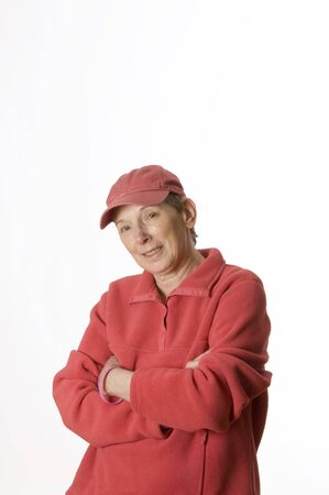 Senior woman breast cancer survivor in a pink cap against a white background.の写真素材