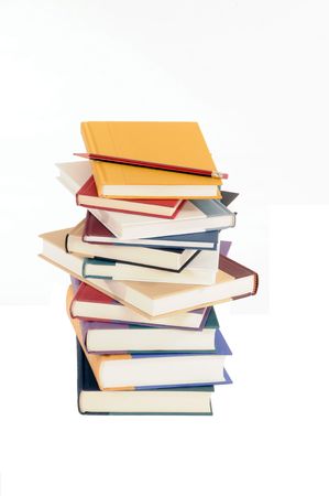 Stack of books with pencil set against a white background.の写真素材