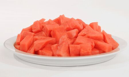 A bowl of watermelon set against a white background.の写真素材