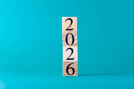 Number 2026 in stacked wooden blocks arranged vertically on vibrant blue background, minimalist...