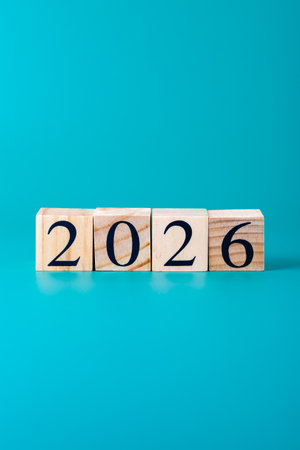 Number 2026 with wooden blocks in horizontal row on vibrant blue background, simple and modern...