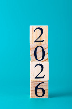 Number 2026 in wooden blocks stacked vertically with turquoise blue background, clean and modern...
