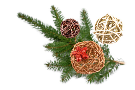 Wicker Christmas ornaments stock images. Christmas decoration on a white background. Spruce twig with christmas balls. Elegant holiday backgroundの写真素材