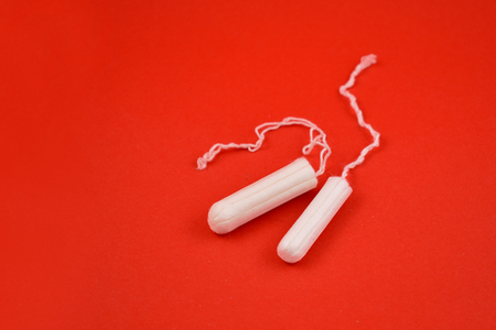 Women's tampons stock images. Feminine hygiene product. White tampons on a red background. Tampons for womenの写真素材