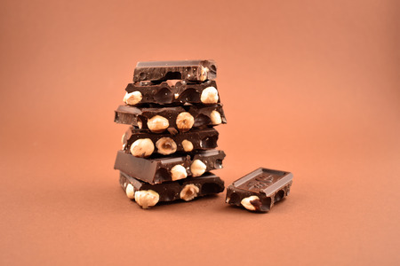 Pile of Chocolate stock images. Nut chocolate on a brown backgroundの写真素材