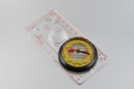 Compass stock images. Magnetic compass on a silver background. Travel aid for navigation