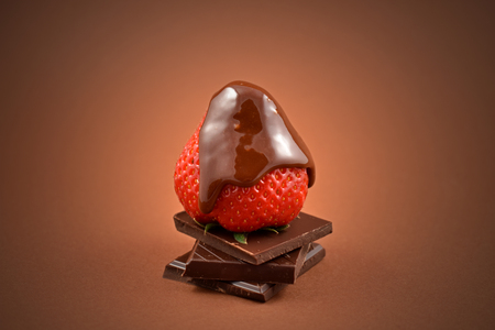 Strawberry with chocolate stock images. Pile of Chocolate with strawberry. Strawberry with chocolate on a brown background. Chocolate fruity delicacy. Valentines Day conceptの写真素材