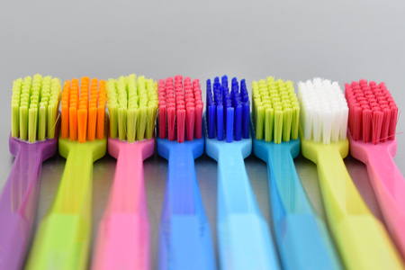 Multicolored toothbrushes stock images. Morning hygiene. Bathroom accessories images. Toothbrush on...