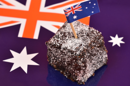 Lamington and Australian flag stock images. Lamington on a national background. Australian sweet delicacy. Important day. Lamington Day background. Australian cake with flagの写真素材