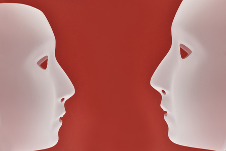 Plastic human face stock images. Plastic white face mask stock images. White mask on a red background. Two plastic human maskの写真素材