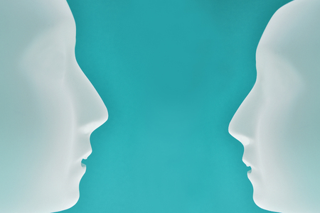 Communication of two heads stock images. Two heads silhouette. Plastic human face stock images....