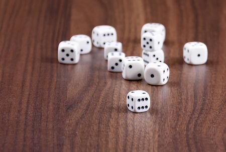 Playing dice stock images. White dice on wooden background. Playing dice on the table. Playing dice...